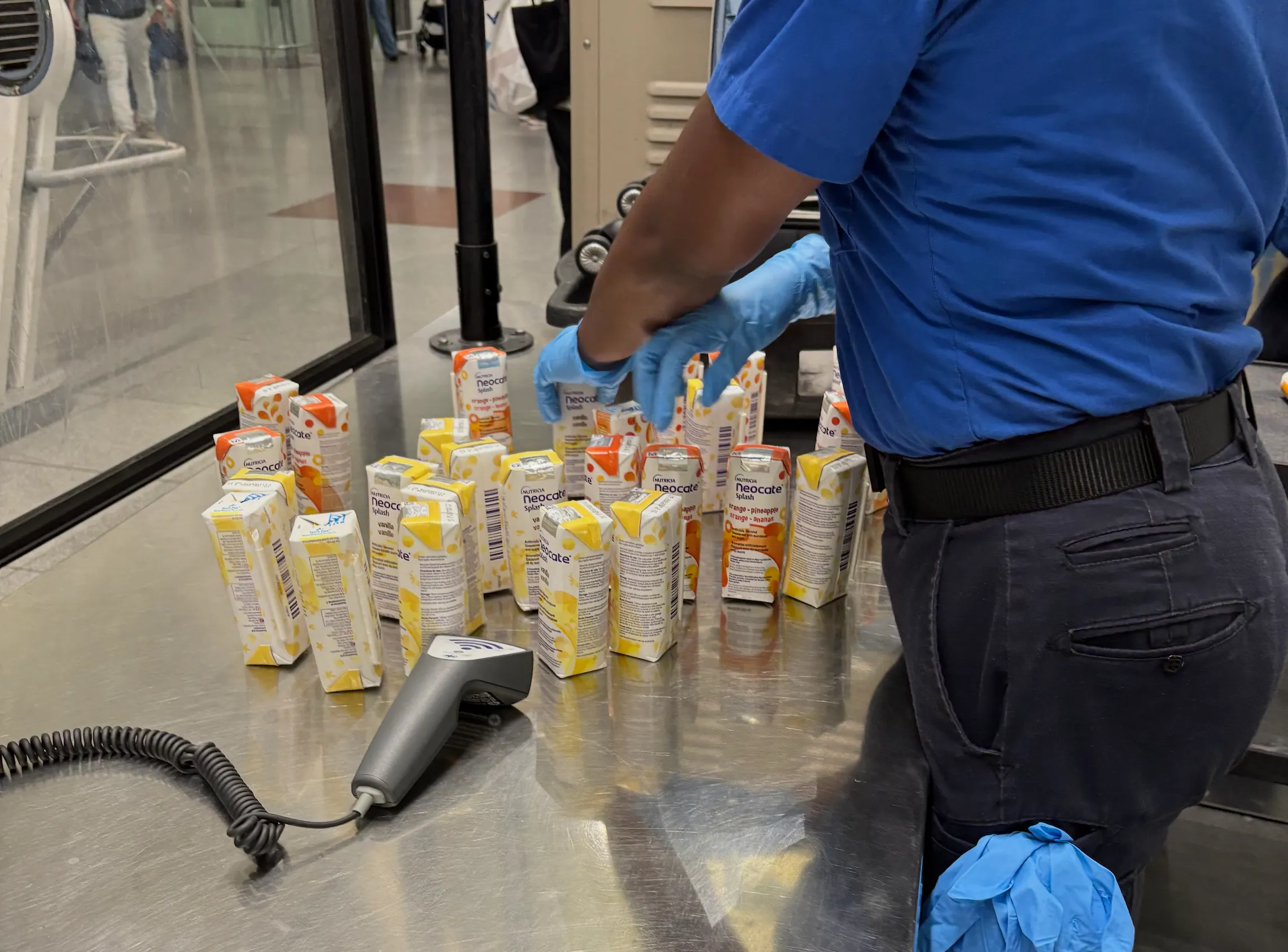 A woman scanning juiboxes at the airport